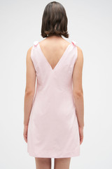 Profile view of model wearing the Oroton Tie Shoulder A-Line Dress in Palest Pink and 100% cotton fabric for Women