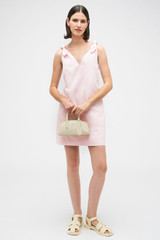 Profile view of model wearing the Oroton Tie Shoulder A-Line Dress in Palest Pink and 100% cotton fabric for Women