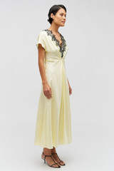 Profile view of model wearing the Oroton Fringe Lace Dress in Lemon Zest and 100% silk for Women .