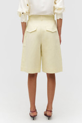 Profile view of model wearing the Oroton Culotte in Lemon Zest and 100% linen for Women .