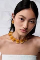 Profile view of model wearing the Oroton Urchin Necklace in Worn Gold and Premium brass material for Women .