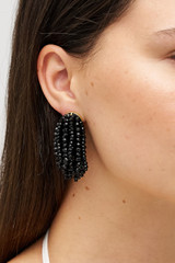 Profile view of model wearing the Oroton Fern Drop Earrings in Black and Premium brass material for Women .