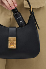 Profile view of model wearing the Oroton Yvonne Baguette in Black and Premium pebble leather for Women .