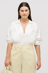 Profile view of model wearing the Oroton Tunic Shirt in Antique White and 100% silk for Women .