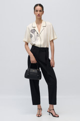 Profile view of model wearing the Oroton Graphic Dandelion Camp Shirt in Ecru and 100% Silk Twill for Women .