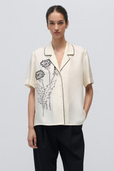 Profile view of model wearing the Oroton Graphic Dandelion Camp Shirt in Ecru and 100% Silk Twill for Women .