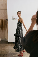 Profile view of model wearing the Oroton Graphic Dandelion Print Sundress in Black and 100% Silk Twill for Women . IP:2