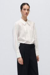 Profile view of model wearing the Oroton Lace Detail Long-Sleeve Shirt in White and 100% Linen for Women . IP:4