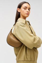 Profile view of model wearing the Oroton Florence Small Shoulder Bag in DARK TAUPE and Premium smooth leather for Women .