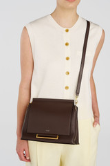 Profile view of model wearing the Oroton Elm Medium Satchel in Coffee Bean and Premium smooth pebble leather for Women .