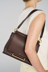Profile view of model wearing the Oroton Elm Medium Satchel in Coffee Bean and Premium smooth pebble leather for Women .