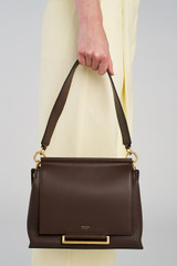 Profile view of model wearing the Oroton Elm Medium Satchel in Coffee Bean and Premium smooth pebble leather for Women .