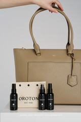 Profile view of model wearing the Oroton Iris Medium Tote in MUSHROOM and Premium pebble leather for Women .
