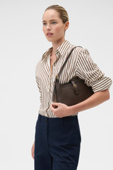 Profile view of model wearing the Oroton Dylan Baguette in Coffee Bean and Premium embossed leather for Women .