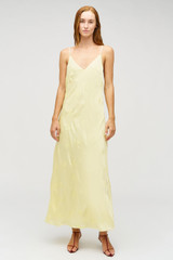 Profile view of model wearing the Oroton Embroidered Leaf Slip Dress in Lemon and 100% viscose fabric for Women .