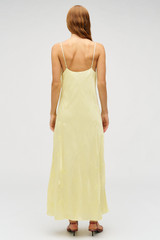 Profile view of model wearing the Oroton Embroidered Leaf Slip Dress in Lemon and 100% viscose fabric for Women .