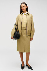 Profile view of model wearing the Oroton Belt Detail Trouser Skirt in Camel and 100% cotton material for Women .