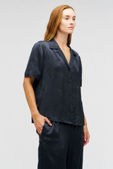 Profile view of model wearing the Oroton Embroidered Leaf Short Sleeve Camp Shirt in Slate and 100% viscose fabric for Women .