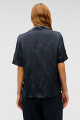 Profile view of model wearing the Oroton Embroidered Leaf Short Sleeve Camp Shirt in Slate and 100% viscose fabric for Women .