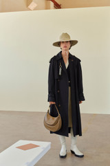 Profile view of model wearing the Oroton Essential Trench in WASHED BLACK and 65% polyester, 35% cotton blend for Women . IP:2