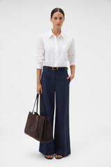 Profile view of model wearing the Oroton Crisp Poplin Shirt in White and 100% cotton fabric for Women .