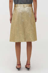 Profile view of model wearing the Oroton Gold Foil Skirt in Gold and Premium metallic blend material (57% polyester, 35% metal fibre, 8% polyamide) for Women .