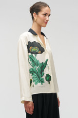 Profile view of model wearing the Oroton Graphic Poppy Ls Camp Shirt in Cream and 100% silk fabric for Women .