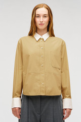 Profile view of model wearing the Oroton Crisp Poplin Shirt in SOFT CAMEL and 100% cotton fabric for Women .