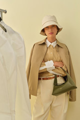 Profile view of model wearing the Oroton Crisp Poplin Shirt in SOFT CAMEL and 100% cotton fabric for Women .