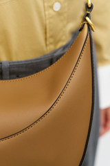 Profile view of model wearing the Oroton FLORENCE MEDIUM HOBO in DARK TAUPE and Smooth leather material for Women .