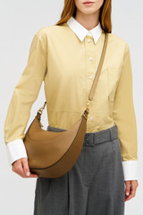 Profile view of model wearing the Oroton FLORENCE MEDIUM HOBO in DARK TAUPE and Smooth leather material for Women . IP:5