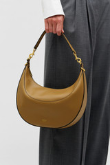 Profile view of model wearing the Oroton FLORENCE MEDIUM HOBO in DARK TAUPE and Smooth leather material for Women .