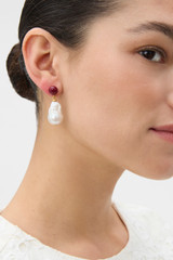 Profile view of model wearing the Oroton Wave Pearl Drop Earrings in PEARL/CHERRY and Premium brass material for Women .
