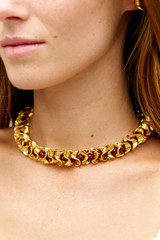Profile view of model wearing the Oroton Wave Necklace in WORN GOLD/CHERRY and Premium brass material for Women .