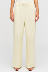 Profile view of model wearing the Oroton Pleat Slouch Pant in Lemon Butter and 58% viscose, 42% linen blend for Women .