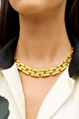 Profile view of model wearing the Oroton James Necklace in Worn Gold and Premium brass material for Women .