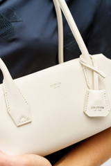 Profile view of model wearing the Oroton Breeze Baguette in Clotted Cream and Premium smooth leather for Women . IP:5