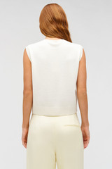 Profile view of model wearing the Oroton Button Front Shell in Cream and 100% wool material for Women .
