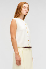 Profile view of model wearing the Oroton Button Front Shell in Cream and 100% wool material for Women .