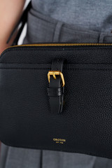 Profile view of model wearing the Oroton Dylan Camera Crossbody in Black and Premium pebble leather for Women .