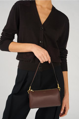 Profile view of model wearing the Oroton Harvey Baguette Crossbody in Chestnut and Premium smooth leather for Women .