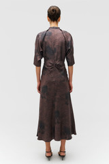 Profile view of model wearing the Oroton Scribble Tree Tie Neck Dress in Chocolate and 100% silk fabric for Women .