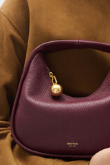 Profile view of model wearing the Oroton Clara Mini Bag in Currant and  for Women . IP:5