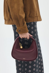 Profile view of model wearing the Oroton Clara Mini Bag in Currant and  for Women . IP:3