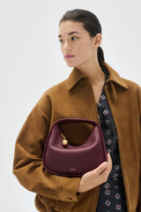 Profile view of model wearing the Oroton Clara Mini Bag in Currant and  for Women . IP:2