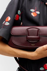 Profile view of model wearing the Oroton Carter Baguette in CURRANT and Premium saffiano leather for Women . IP:5