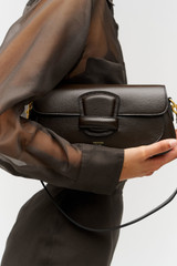 Profile view of model wearing the Oroton Carter Baguette in Dark Chocolate and Premium saffiano leather for Women . IP:4