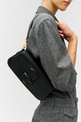 Profile view of model wearing the Oroton Carter Baguette in Black and Premium saffiano leather for Women .