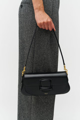 Profile view of model wearing the Oroton Carter Baguette in Black and Premium saffiano leather for Women .