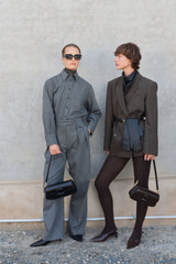 Profile view of model wearing the Oroton Tweed Pleat Pant in CHARCOAL TWEED and Premium blend of 29% polyester, 24% wool, 18% acrylic, 15% silk, 13% viscose, and 1% elastane for Women .